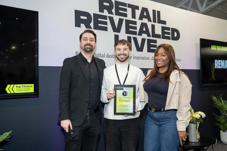 Three people pose with a "Top Drawer" award certificate for "Remail" at the Retail Revealed Live event.